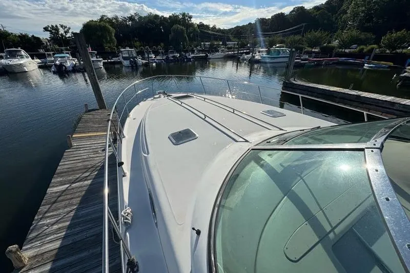 Slide: The Image of 2001 Sea Ray 380 Sundancer docked at a marina under a clear sky. - 49