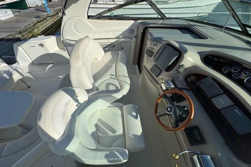 Slide: The Image of 2001 Sea Ray 380 Sundancer cockpit with white leather seats and modern dashboard. - 54