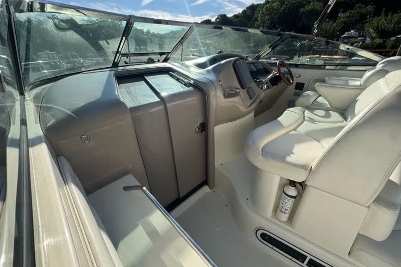 Slide: The Image of 2001 Sea Ray 380 Sundancer cockpit with white seating and control panel. - 6