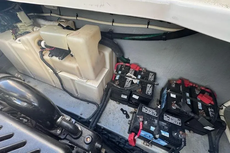 Slide: The Image of Engine compartment of a 2001 Sea Ray 380 Sundancer with batteries and wiring visible. - 61