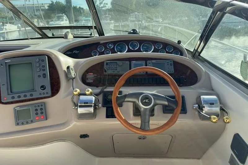 Slide: The Image of Helm of 2001 Sea Ray 380 Sundancer with wood steering wheel and navigation instruments. - 7