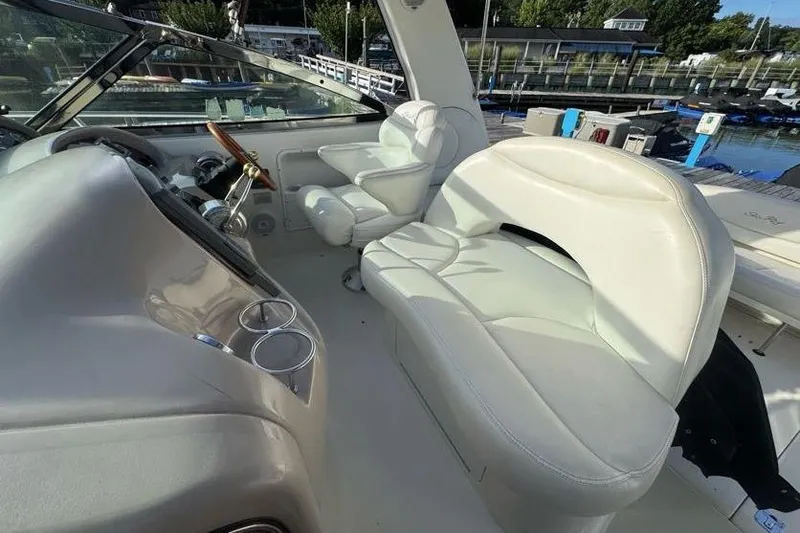 Slide: The Image of 2001 Sea Ray 380 Sundancer cockpit with white leather seating and steering wheel. - 8