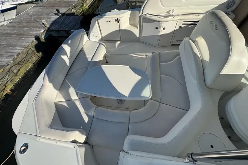 Slide: The Image of 2001 Sea Ray 380 Sundancer boat interior with white seating and table. - 9