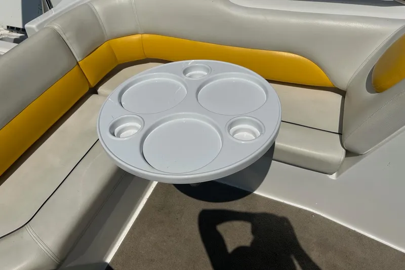 Slide: The Image of 2014 Hurricane SunDeck Sport 188 IO boat interior with round table and cushioned seating. - 5