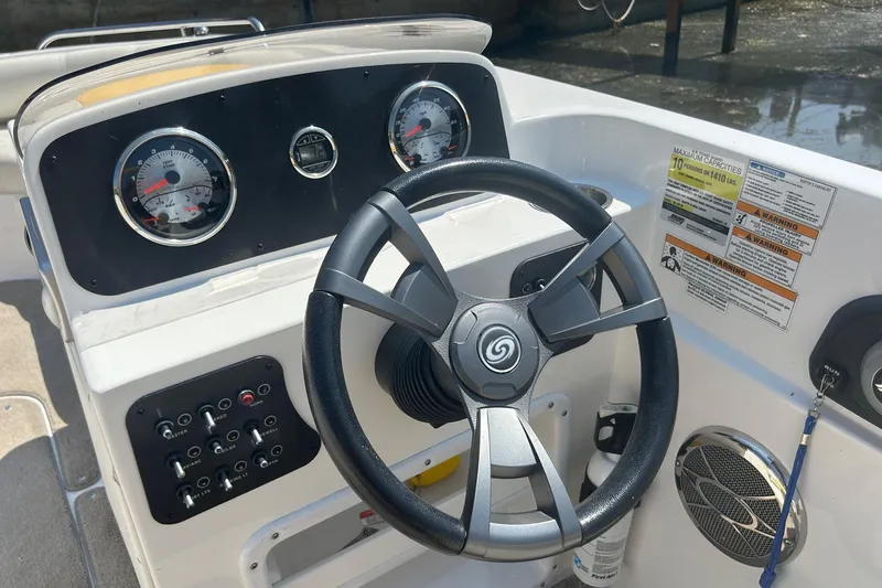 Slide: The Image of 2014 Hurricane SunDeck Sport 188 IO boat dashboard with steering wheel and gauges. - 6