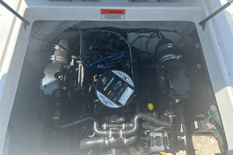 Slide: The Image of Engine compartment of a 2014 Hurricane SunDeck Sport 188 IO boat, featuring a MerCruiser engine. - 9