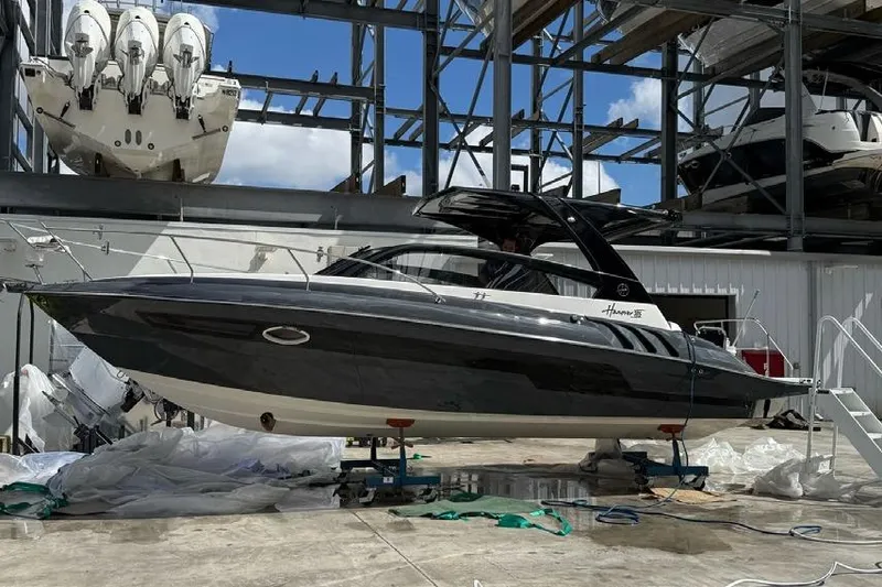 Slide: The Image of 2025 Hanover 305 Gray & Black Edition boat in storage facility. - 1
