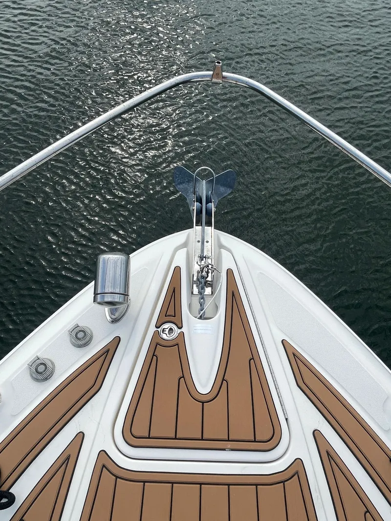 Slide: The Image of Bow of 2012 Sea Ray 330 Sundancer on water, featuring teak decking. - 10