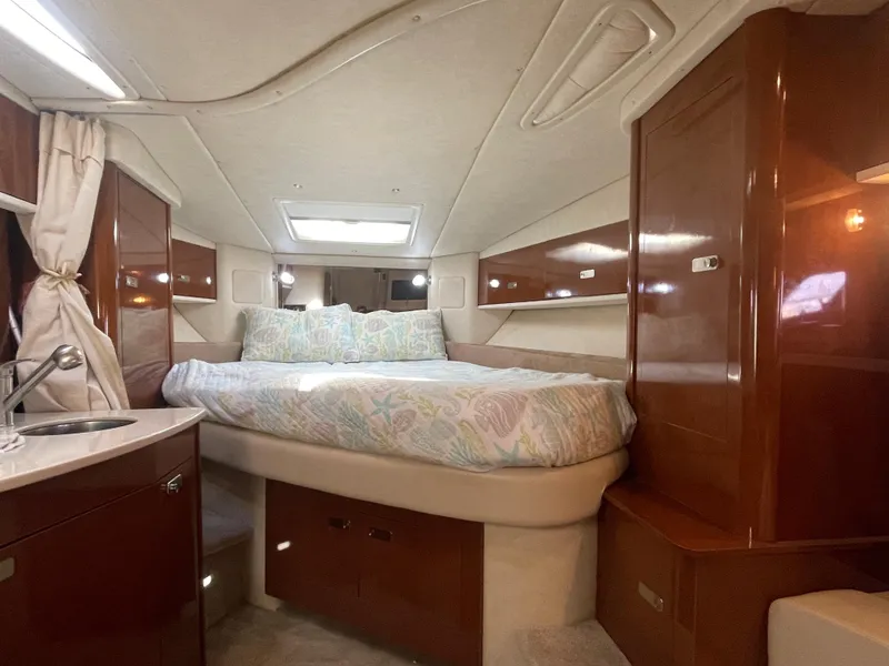 Slide: The Image of Luxurious interior of 2012 Sea Ray 330 Sundancer with cozy bed and elegant wood finish. - 13