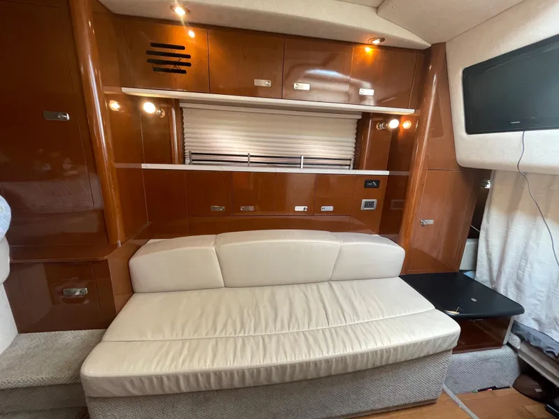 Slide: The Image of Interior of 2012 Sea Ray 330 Sundancer with white sofa and wooden cabinetry. - 15