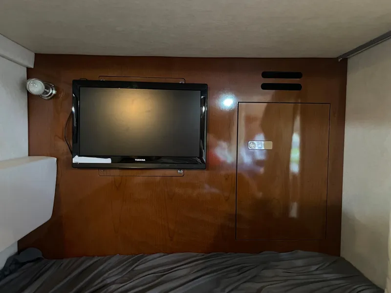 Slide: The Image of Interior cabin of 2012 Sea Ray 330 Sundancer with TV and wooden paneling. - 20