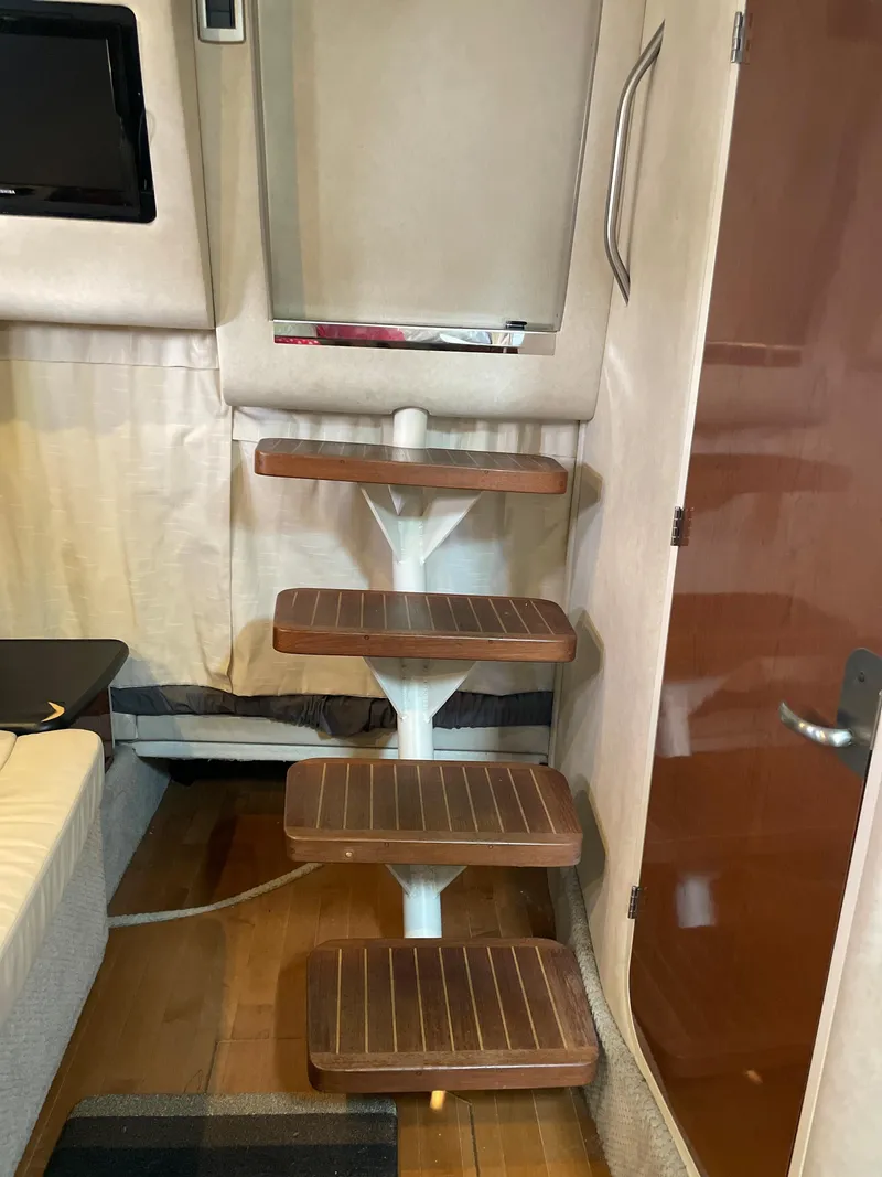 Slide: The Image of Interior stairs of a 2012 Sea Ray 330 Sundancer yacht, featuring wooden steps. - 21