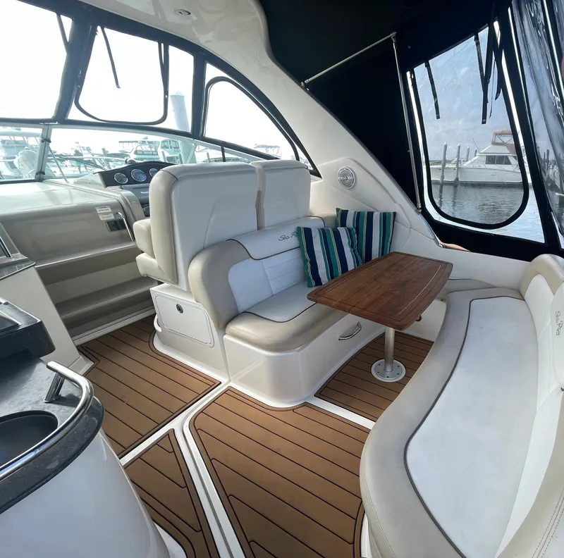 Slide: The Image of Interior of 2012 Sea Ray 330 Sundancer with seating and table, docked at marina. - 5