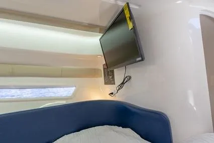 Slide: The Image of 2024 Hanover 305 White & Blue Edition interior with mounted TV and modern design. - 11