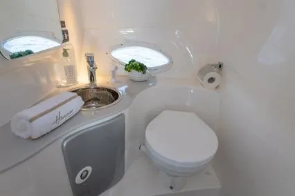 Slide: The Image of 2024 Hanover 305 White & Blue Edition bathroom with modern sink and toilet. - 13