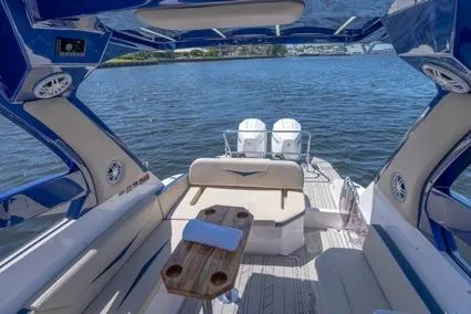 Slide: The Image of 2024 Hanover 305 White & Blue Edition boat interior with luxurious seating and scenic water view. - 6