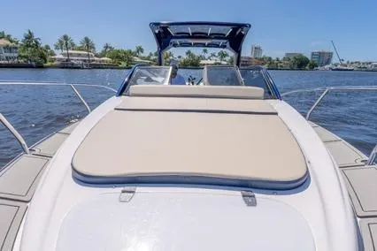 Slide: The Image of 2024 Hanover 305 White & Blue Edition boat on a sunny waterway. - 7