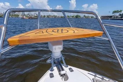 Slide: The Image of 2024 Hanover 305 White & Blue Edition boat with wooden deck detail on water. - 9