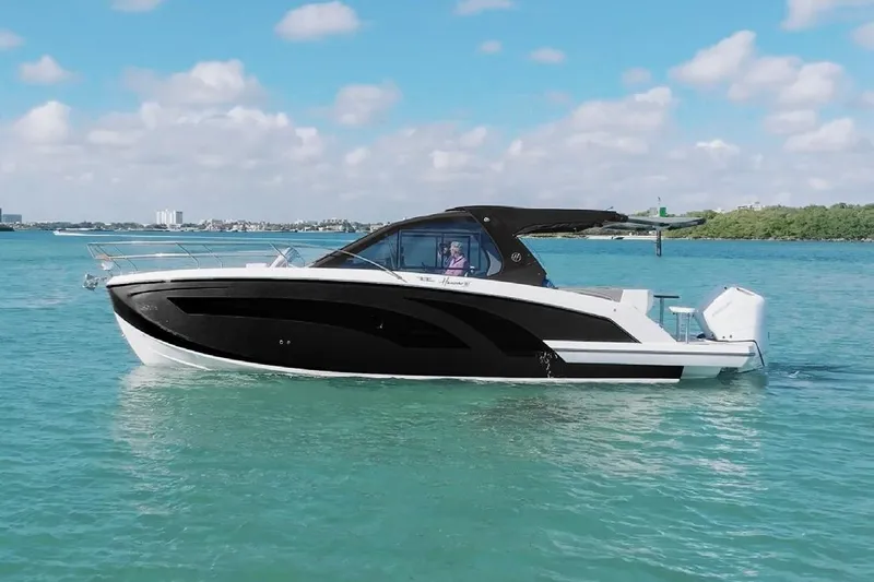 Slide: The Image of 2026 Hanover 387 Tuxedo Luxury Edition boat cruising on clear blue water. - 0
