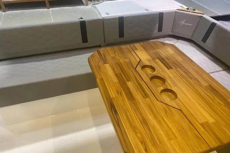 Slide: The Image of Luxurious interior of 2026 Hanover 387 Tuxedo, featuring elegant wood table and plush seating. - 2