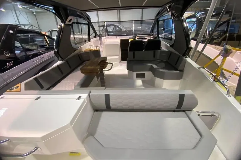 Slide: The Image of Interior of 2026 Hanover 387 Tuxedo Luxury Edition boat, featuring sleek seating and modern design. - 9