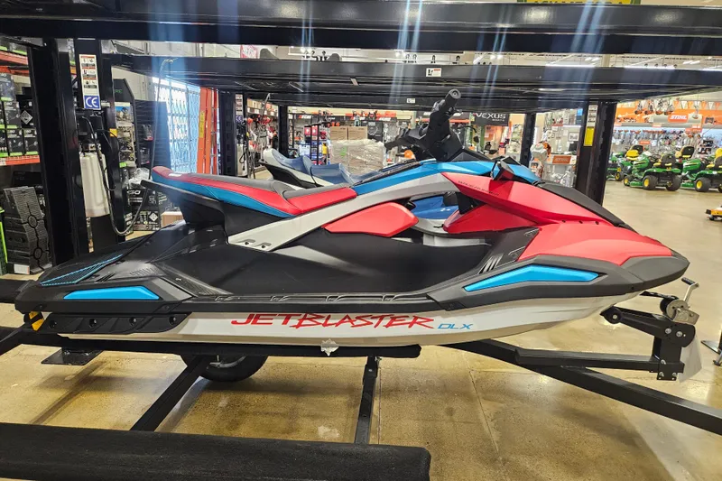 Slide: The Image of 2025 Yamaha WaveRunner Jet Blaster DLX 3 Pass in showroom, vibrant red and blue design. - 3