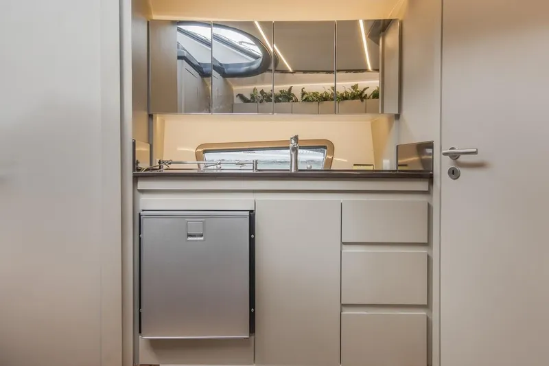 Slide: The Image of Modern kitchen interior in 2024 Hanover 415 Pure Gray, featuring sleek cabinetry and mirrored accents. - 12