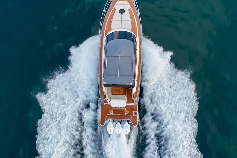 Slide: The Image of Aerial view of 2024 Hanover 415 Pure Gray yacht cruising on water. - 6