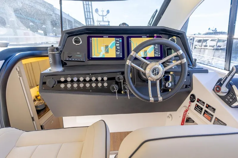 Slide: The Image of 2024 Hanover 415 Pure Gray yacht helm with navigation screens and controls. - 7