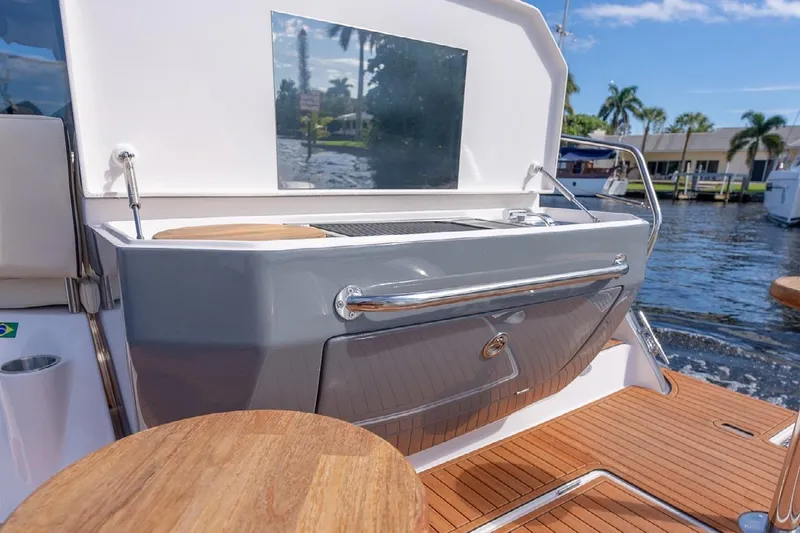 Slide: The Image of 2024 Hanover 415 Pure Gray yacht with sleek outdoor kitchen and wooden deck. - 9