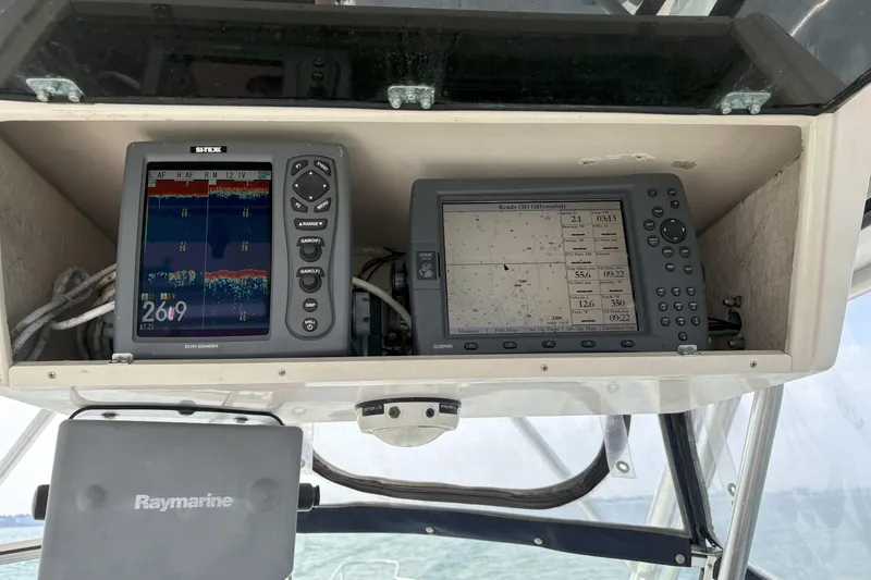 Slide: The Image of 1994 Grady-White Marlin 280 boat dashboard with navigation and sonar equipment. - 3