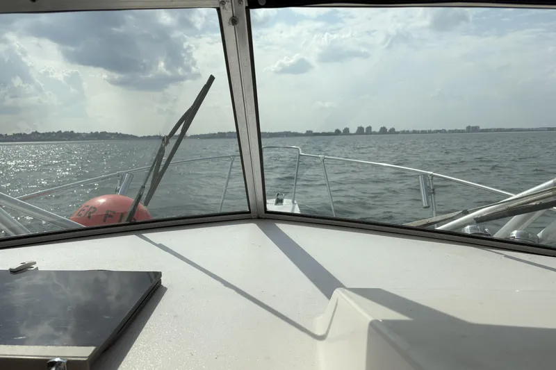 Slide: The Image of View from 1994 Grady-White Marlin 280 boat, overlooking calm sea and distant shoreline. - 4