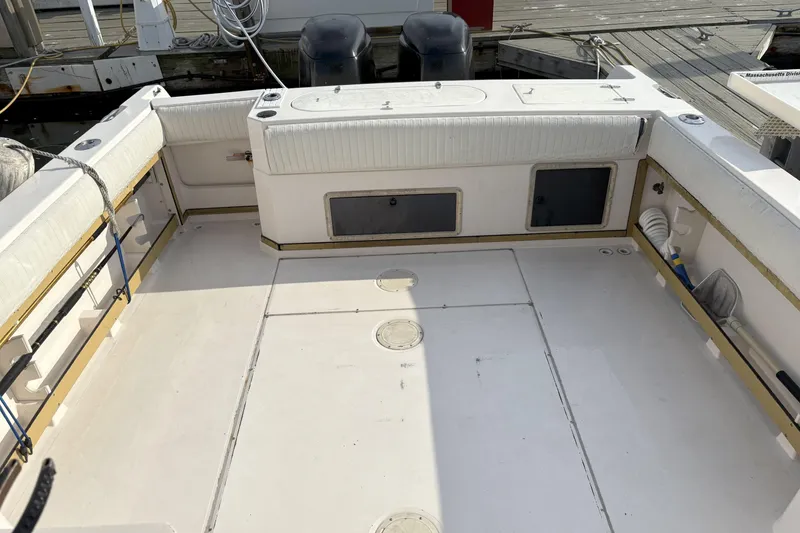Slide: The Image of 1994 Grady-White Marlin 280 boat deck with seating and storage compartments. - 5