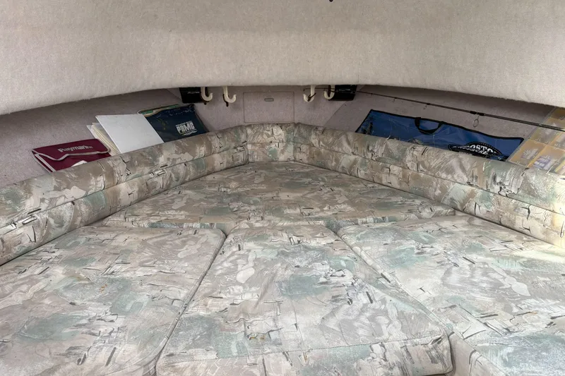 Slide: The Image of 1994 Grady-White Marlin 280 cabin interior with patterned cushions and storage compartments. - 7