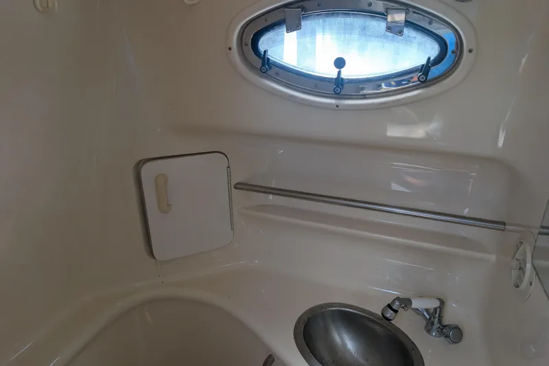 Slide: The Image of Interior of 1996 Sea Ray 330 Sundancer boat bathroom with sink and porthole window. - 20