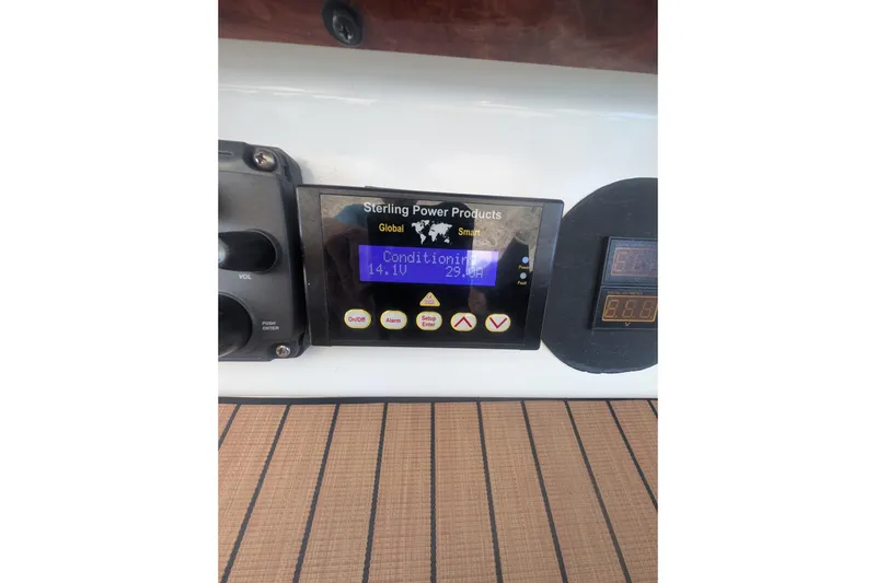 Slide: The Image of Control panel on 1996 Sea Ray 330 Sundancer boat, displaying voltage and settings. - 24