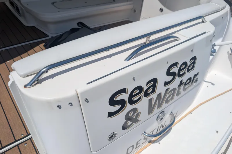 Slide: The Image of 1996 Sea Ray 330 Sundancer boat with "Sea Sea & Water" signage on deck. - 4