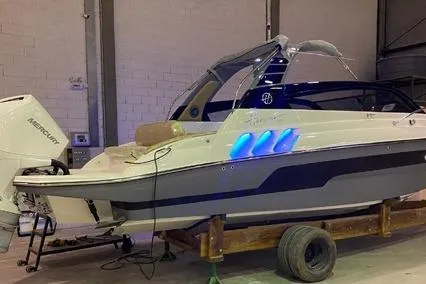 Slide: The Image of 2024 Hanover 305 White & Gray Edition boat in a garage with blue accent lights. - 3