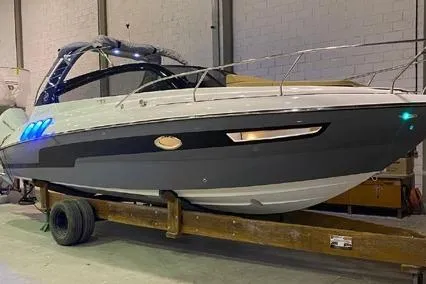 Slide: The Image of 2024 Hanover 305 White & Gray Edition boat in indoor storage on a trailer. - 5