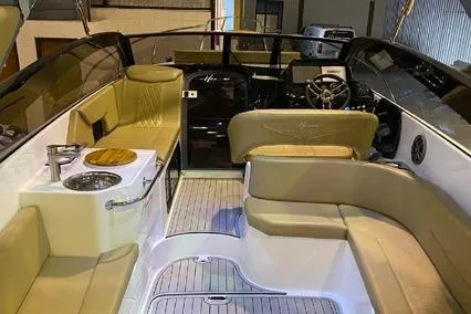 Slide: The Image of 2024 Hanover 305 White & Gray Edition boat interior with luxurious seating and modern dashboard. - 6