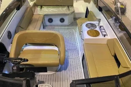 Slide: The Image of 2024 Hanover 305 White & Gray Edition boat interior with beige seating and modern amenities. - 7