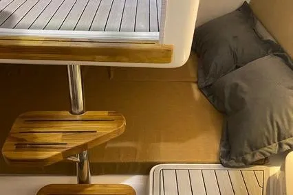 Slide: The Image of 2024 Hanover 305 White & Gray Edition interior with wooden steps and cozy bedding. - 9