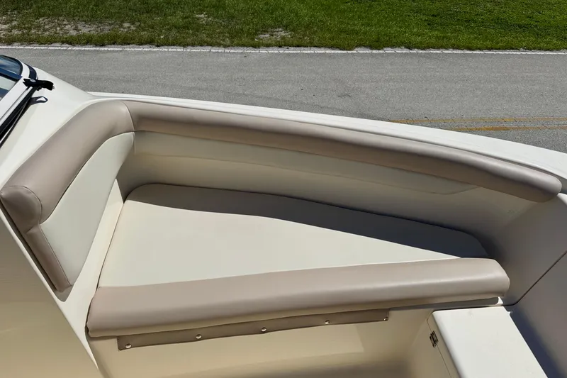 Slide: The Image of 2021 Scout 210 Dorado boat interior with beige cushioned seating. - 12