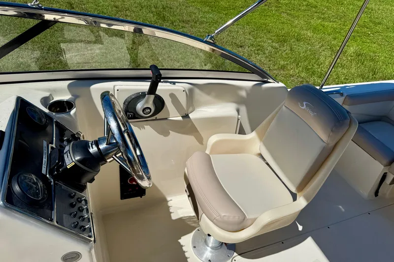 Slide: The Image of 2021 Scout 210 Dorado boat cockpit with steering wheel and captain's chair. - 14