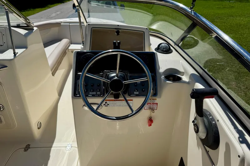 Slide: The Image of 2021 Scout 210 Dorado boat cockpit with steering wheel and control panel. - 15