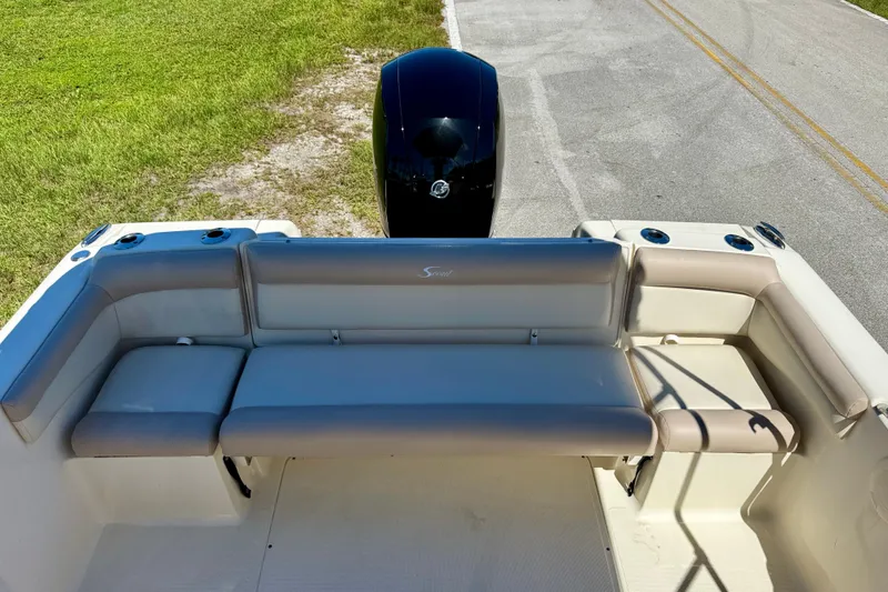 Slide: The Image of 2021 Scout 210 Dorado boat interior with cushioned seating and outboard motor. - 20
