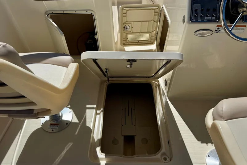 Slide: The Image of 2021 Scout 210 Dorado boat interior with open storage compartments and seating. - 22