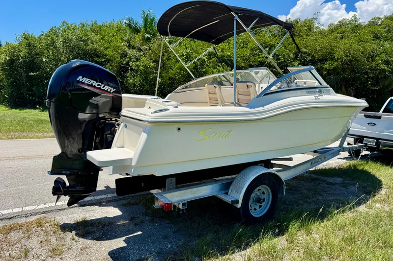 Slide: The Image of 2021 Scout 210 Dorado boat on trailer with Mercury outboard, parked roadside. - 5
