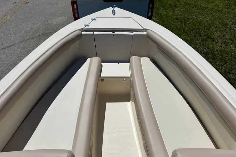 Slide: The Image of 2021 Scout 210 Dorado boat interior with beige seating and storage compartment. - 8