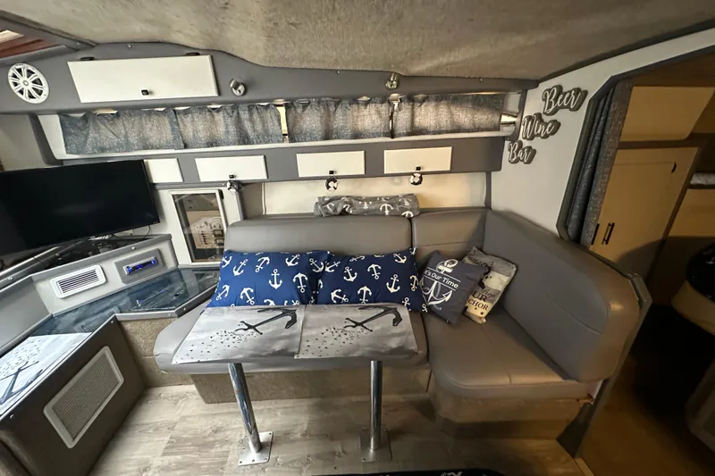 Slide: The Image of Interior of 1986 Sea Ray 340 Express Cruiser with nautical-themed cushions and seating. - 11